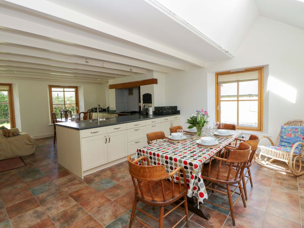 A kitchen with a dining area and island at Bryn Isaf in Swyddffynnon near Pontrhydfendigaid