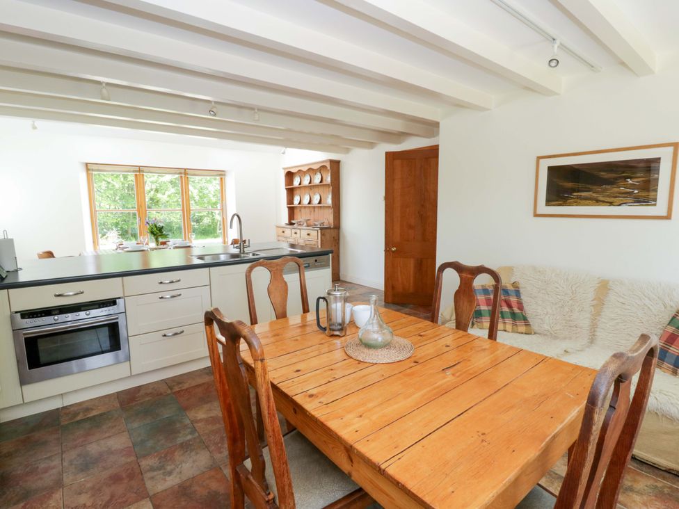 A kitchen with a dining table and chairs at Bryn Isaf in Swyddffynnon near Pontrhydfendigaid
