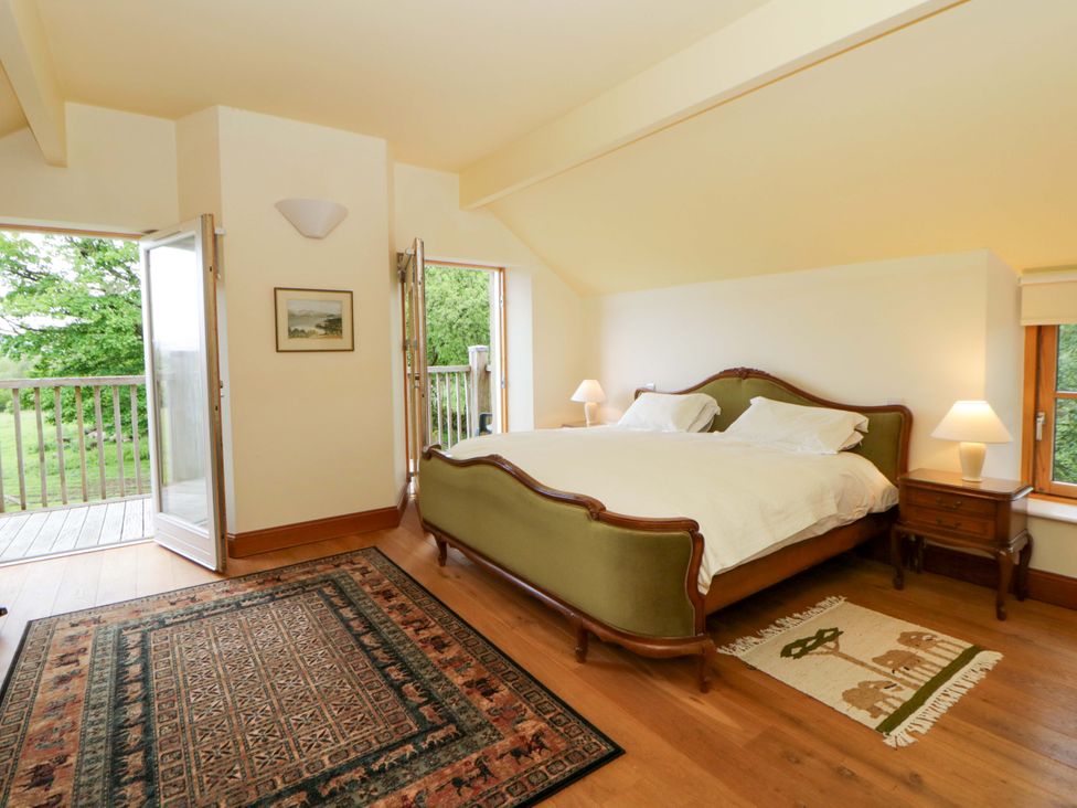 A bedroom with a bed and nightstand at Bryn Isaf in Swyddffynnon near Pontrhydfendigaid