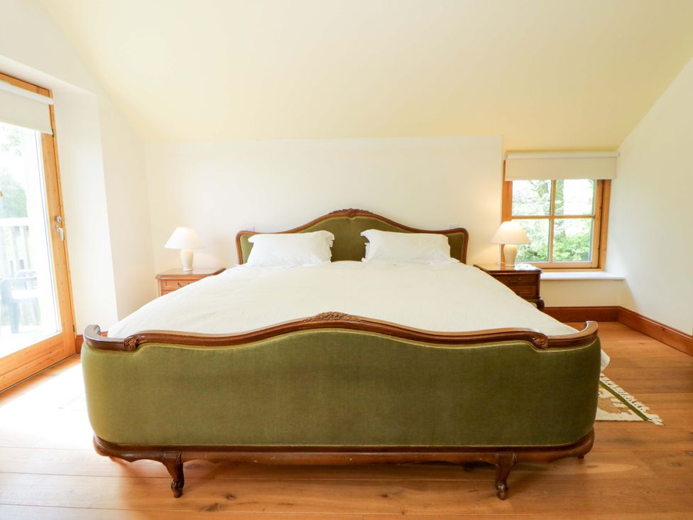 A bedroom with a bed and side table at Bryn Isaf in Swyddffynnon near Pontrhydfendigaid