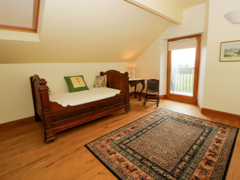 A bedroom with a single bed and table at Bryn Isaf in Swyddffynnon near Pontrhydfendigaid