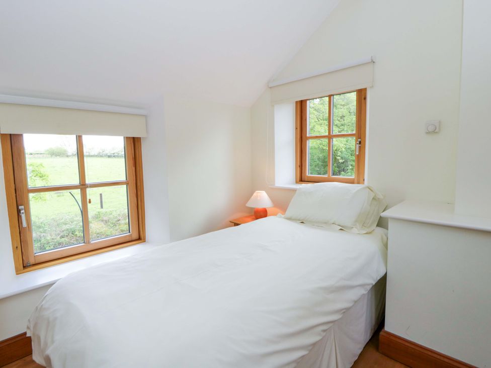 A bedroom with a bed and window at Bryn Isaf in Swyddffynnon near Pontrhydfendigaid