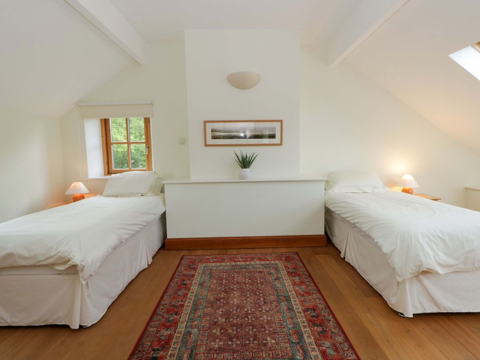 A bedroom with two beds and a window at Bryn Isaf in Swyddffynnon near Pontrhydfendigaid
