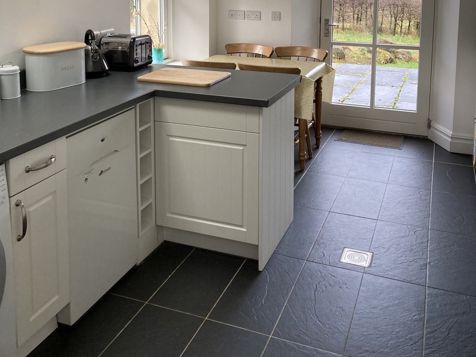 A kitchen with a door leading outside at Ty Cellin in Ystrad Meurig