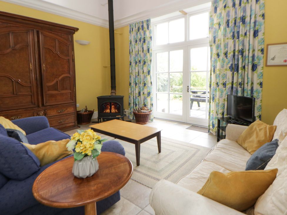 A living room with a sofa and coffee table at Ty Cellin in Swyddffynnon near Pontrhydfendigaid