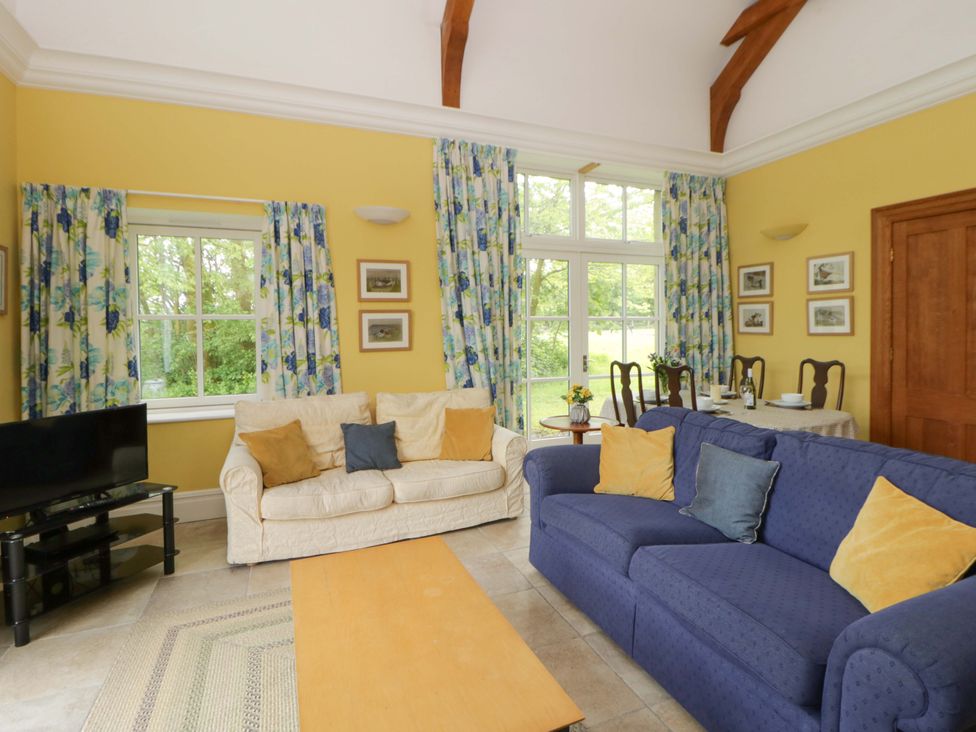 A living room with a sofa and television at Ty Cellin in Swyddffynnon near Pontrhydfendigaid
