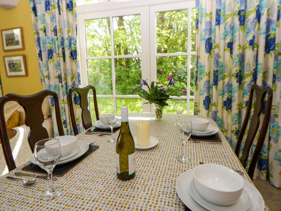 A dining room with a table set for a meal at Ty Cellin in Swyddffynnon near Pontrhydfendigaid