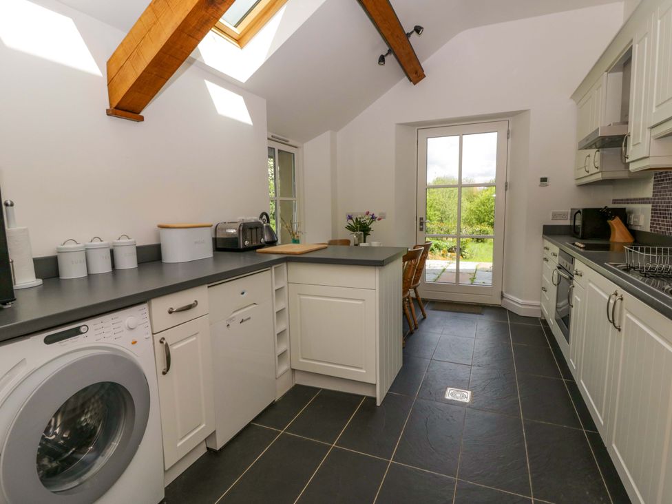 A kitchen with appliances and a door to the outside at Ty Cellin in Swyddffynnon near Pontrhydfendigaid