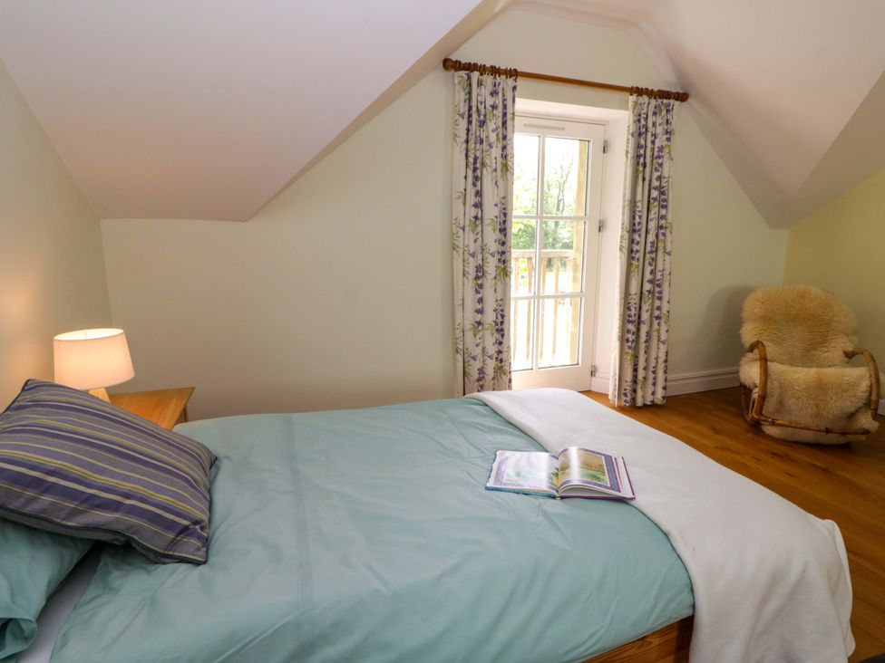 A bedroom with a bed and a window at Ty Cellin in Swyddffynnon near Pontrhydfendigaid