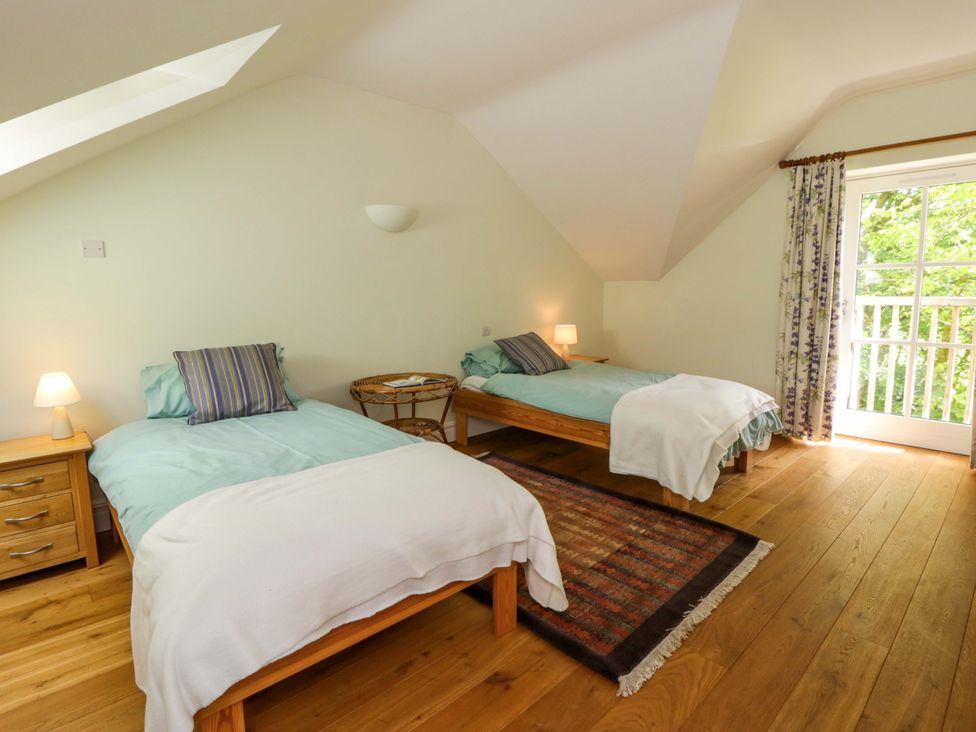 A bedroom with two beds and a window at Ty Cellin in Swyddffynnon near Pontrhydfendigaid
