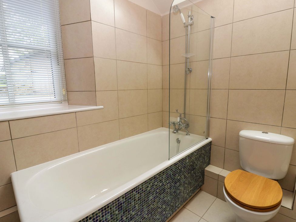 A bathroom with a bathtub and shower at Ty Cellin in Swyddffynnon near Pontrhydfendigaid