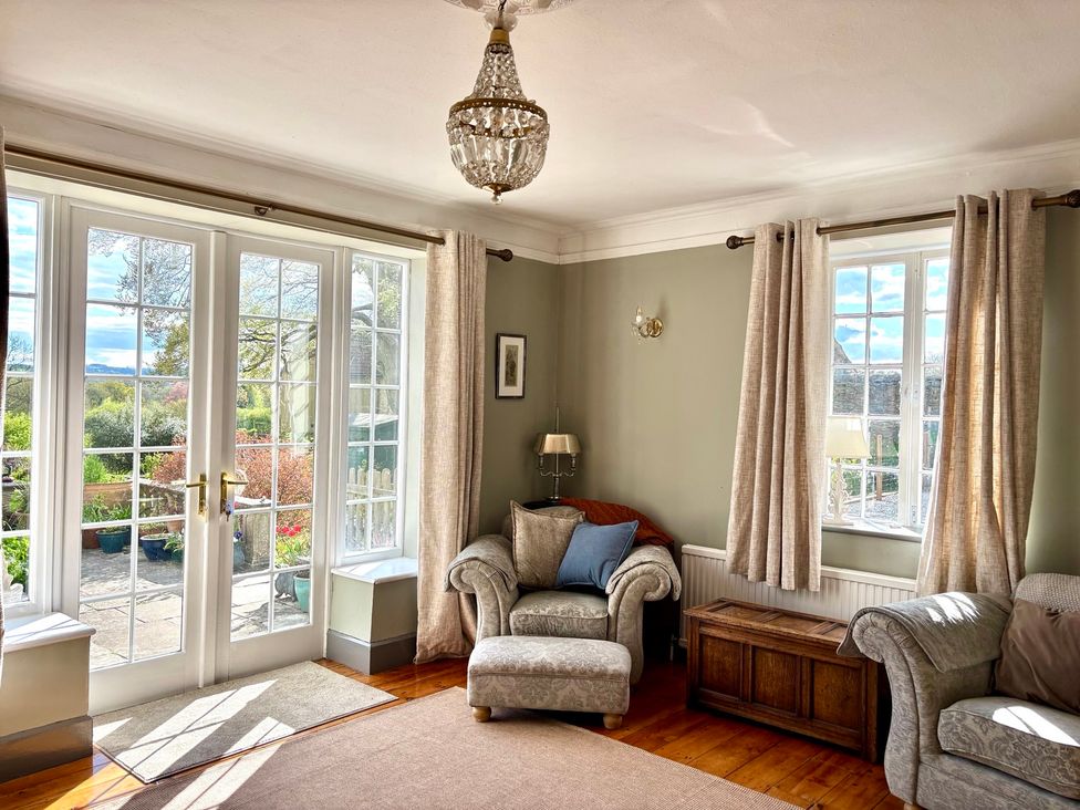 A living room with a sofa and armchair at Humphreston House in Temple Cloud