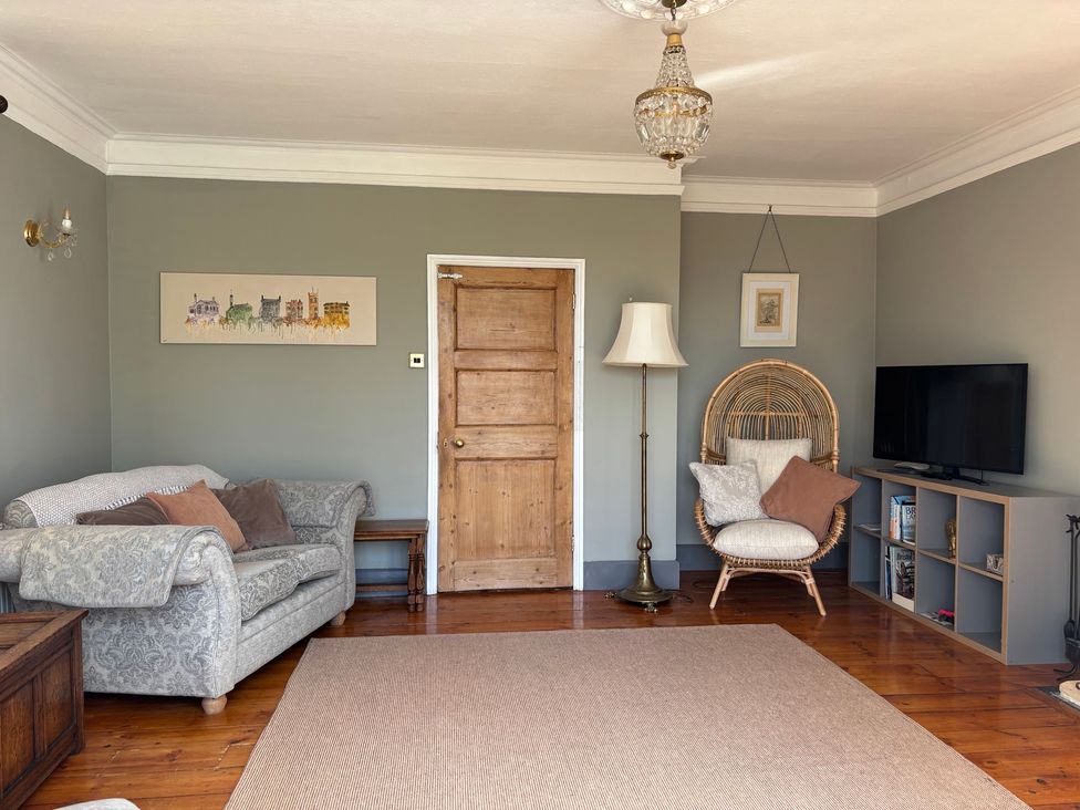 A living room with a sofa and a television at Humphreston House in Temple Cloud