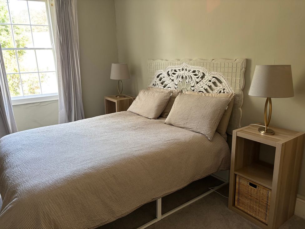 A bedroom with a bed and nightstand at Humphreston House in Temple Cloud