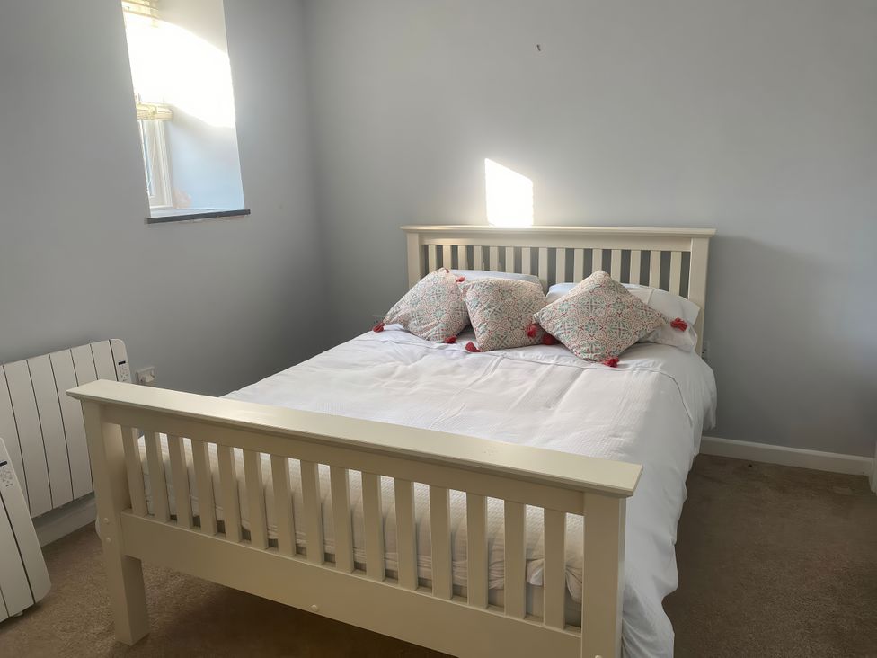 A bedroom with a bed and pillows at Mys Hedra Farm in Penzance