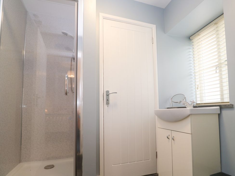 A bathroom with a shower and a basin at Mys Hedra Farm in St Buryan