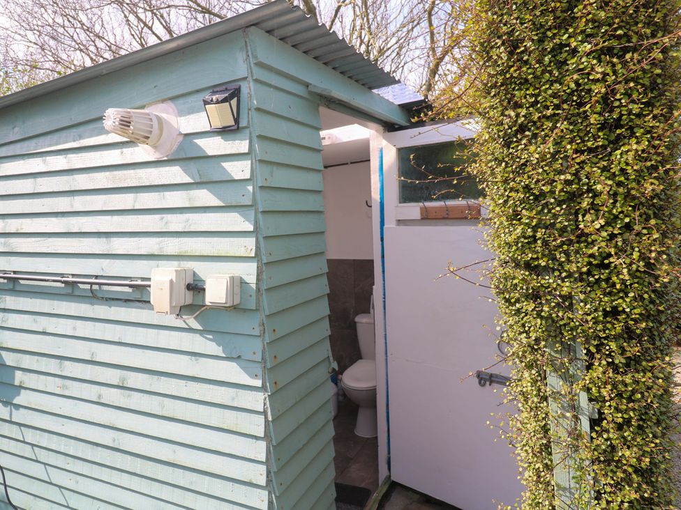 An outdoor restroom with a toilet at Higher Merther Farm Shepherds Hut Helston