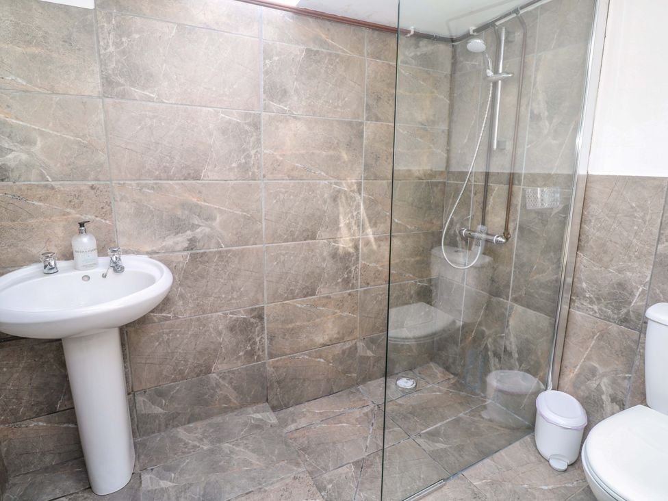 A bathroom with a sink shower and toilet at Higher Merther Farm Shepherds Hut Helston