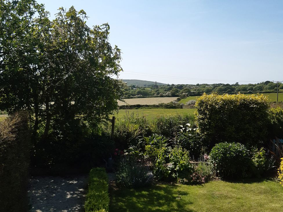 A garden with trees and bushes at Higher Merther Farm Shepherds Hut Sithney near Helston