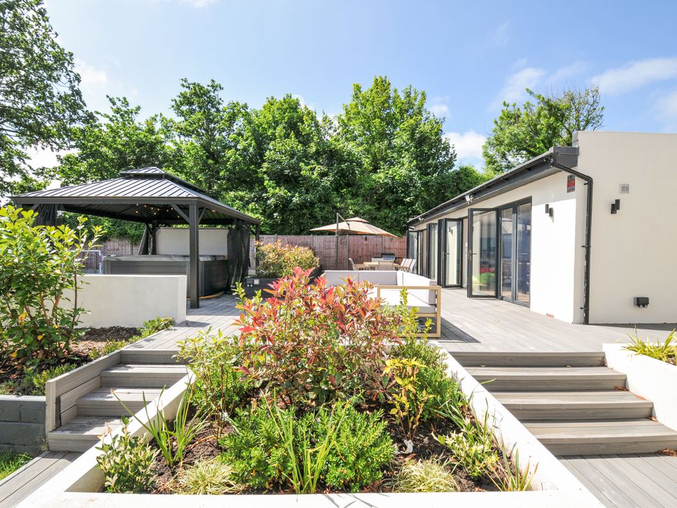 A garden with a gazebo and hot tub at Boathyde in Northam