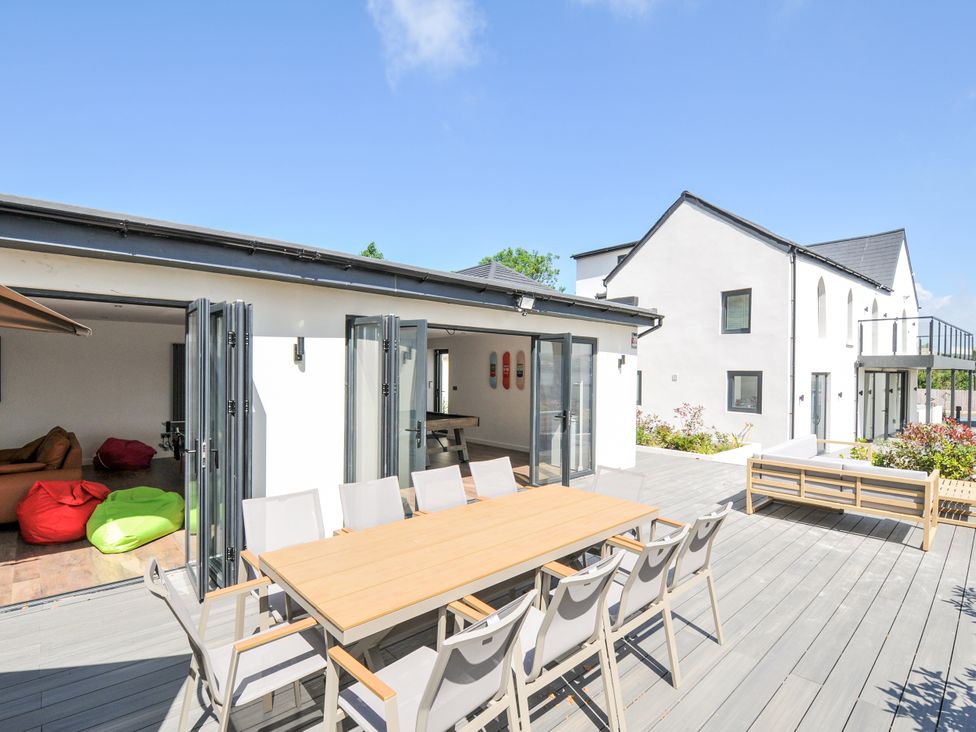 An outdoor patio with a dining table and bean bags at Boathyde in Northam