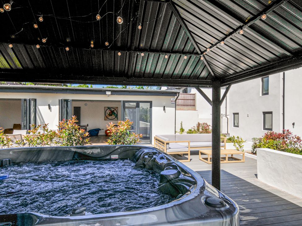 An outdoor space with a hot tub and seating areas at Boathyde in Northam