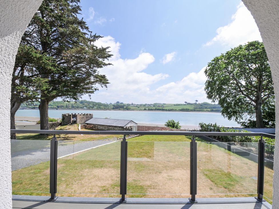 A view from a balcony overlooking water and grass at Boathyde Northam