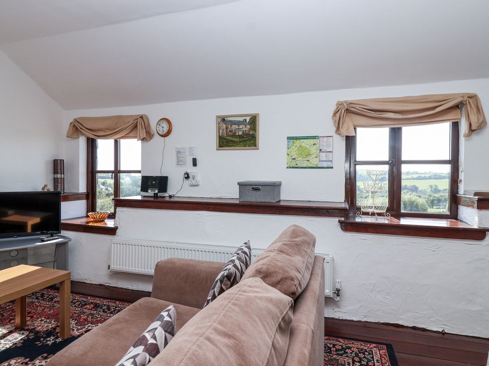 A snug with a sofa and TV at The Dairy Common Moor near Liskeard
