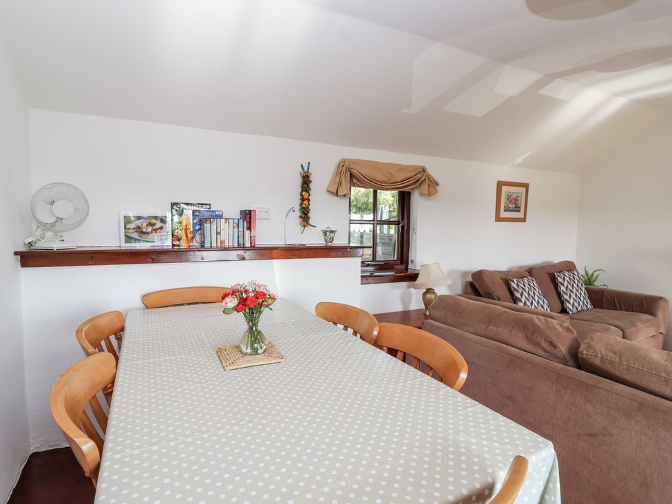 A dining room with a table and chairs at The Dairy in Common Moor near Liskeard