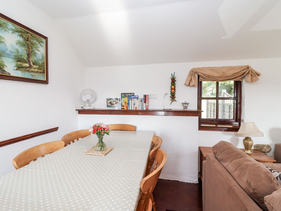 A dining room with table and chairs at The Dairy in Common Moor near Liskeard