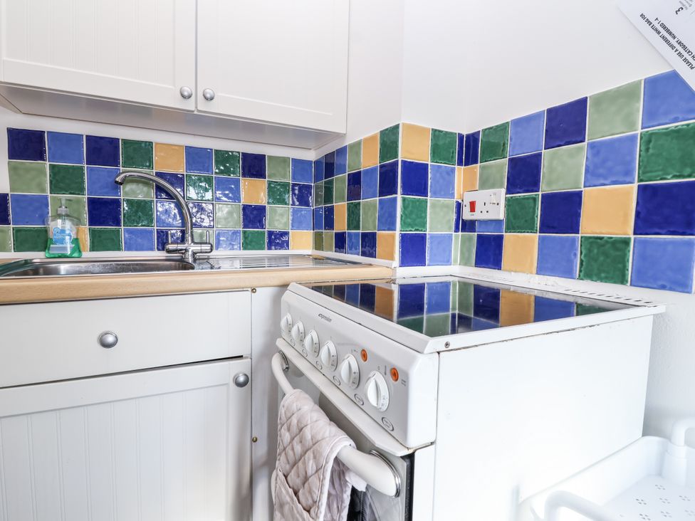 A kitchen with a sink and stove at The Dairy in Common Moor near Liskeard