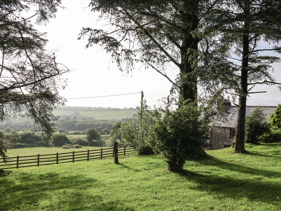 A view of trees and a building in a field at The Dairy Common Moor near Liskeard