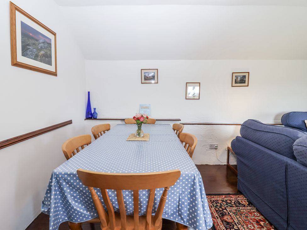 A dining room with a table and chairs at The Byre in Common Moor near Liskeard