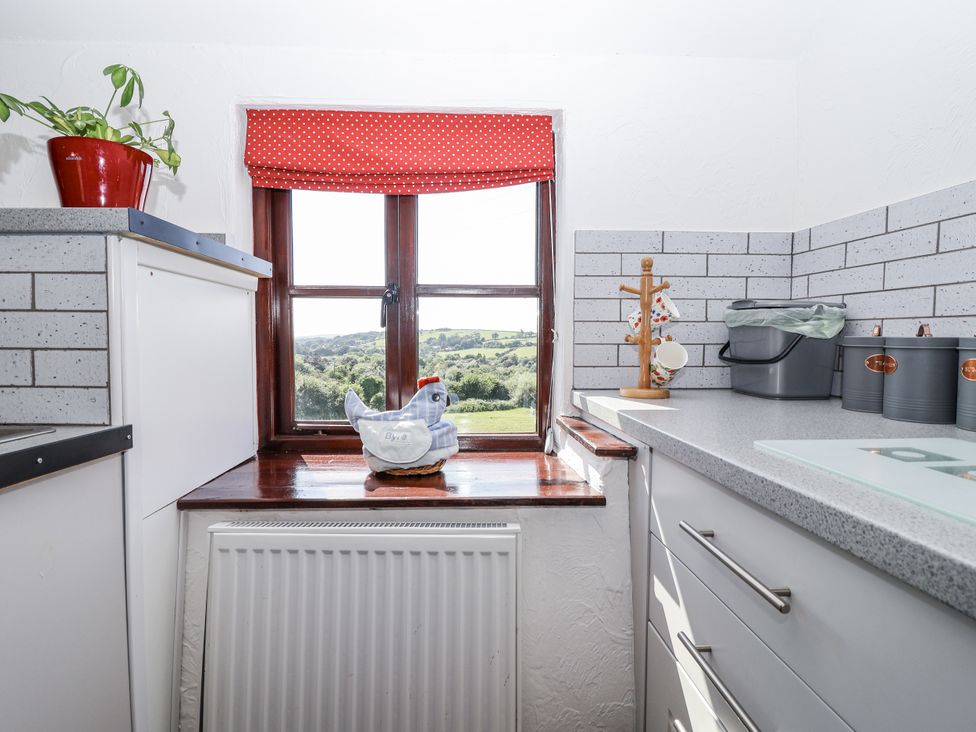 A kitchen with a window and countertop at The Byre Common Moor near Liskeard