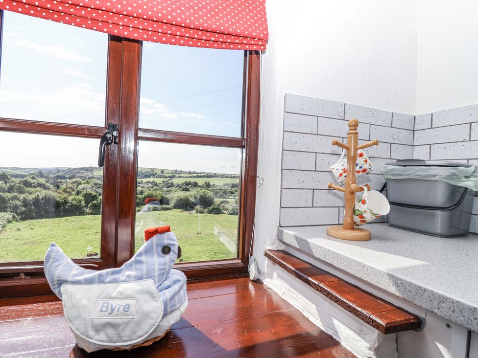 A kitchen with window view of the landscape at The Byre in Common Moor near Liskeard