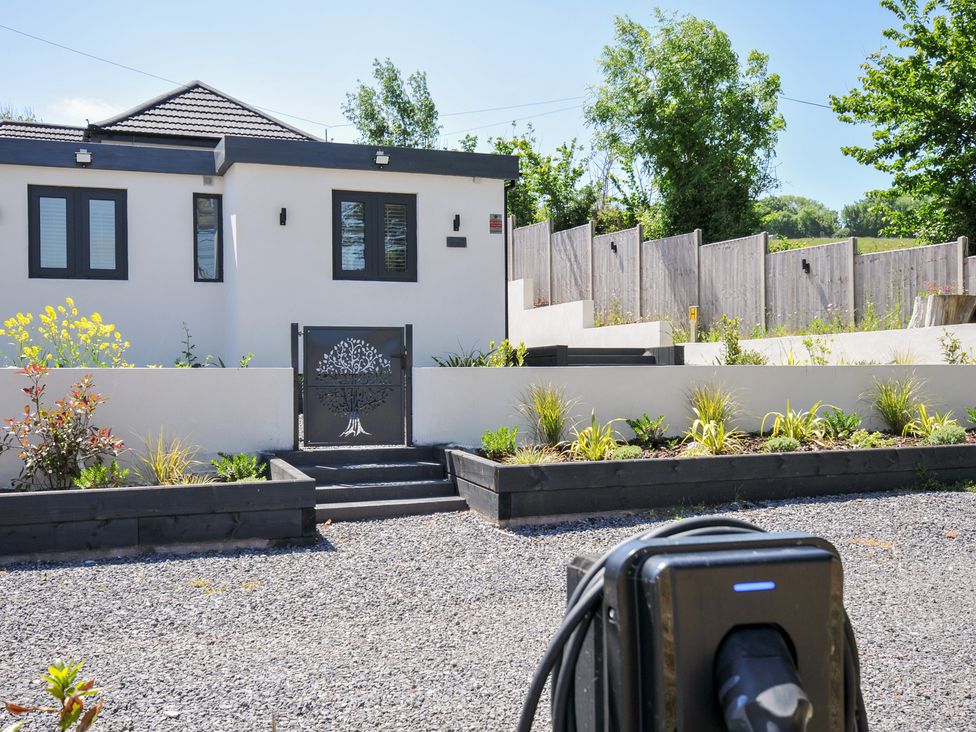 A house with a garden and electric vehicle charger at The Mooring in Northam