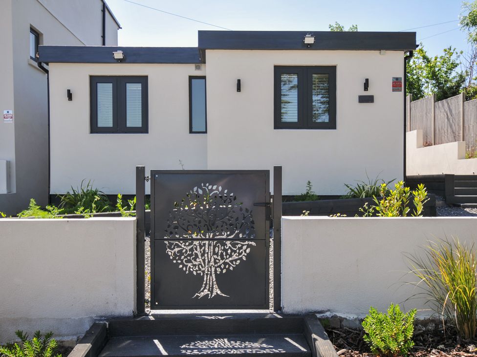 A house exterior with a decorative gate and plants at The Mooring in Northam