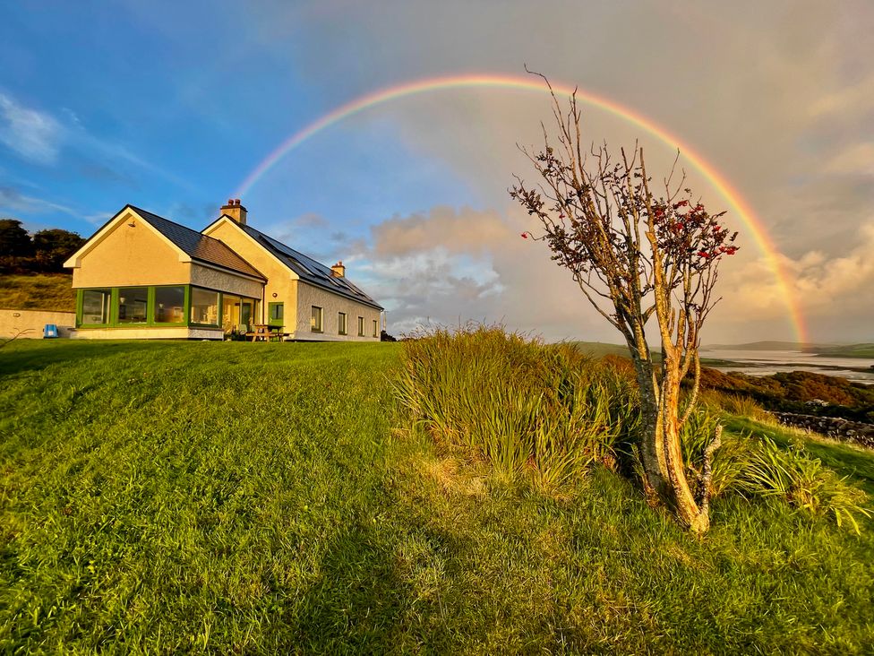 A house with a rainbow in the sky at Lighthouse Hill in Mulranny, County Mayo