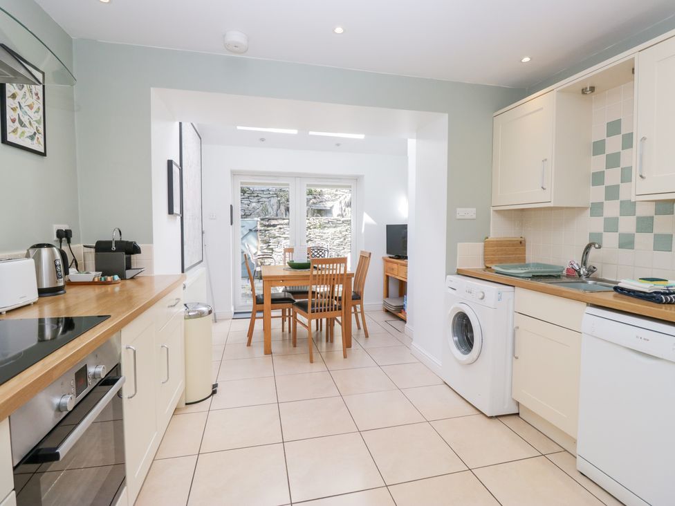 A kitchen with a dining table and chairs at Rothay Cottage in Ambleside