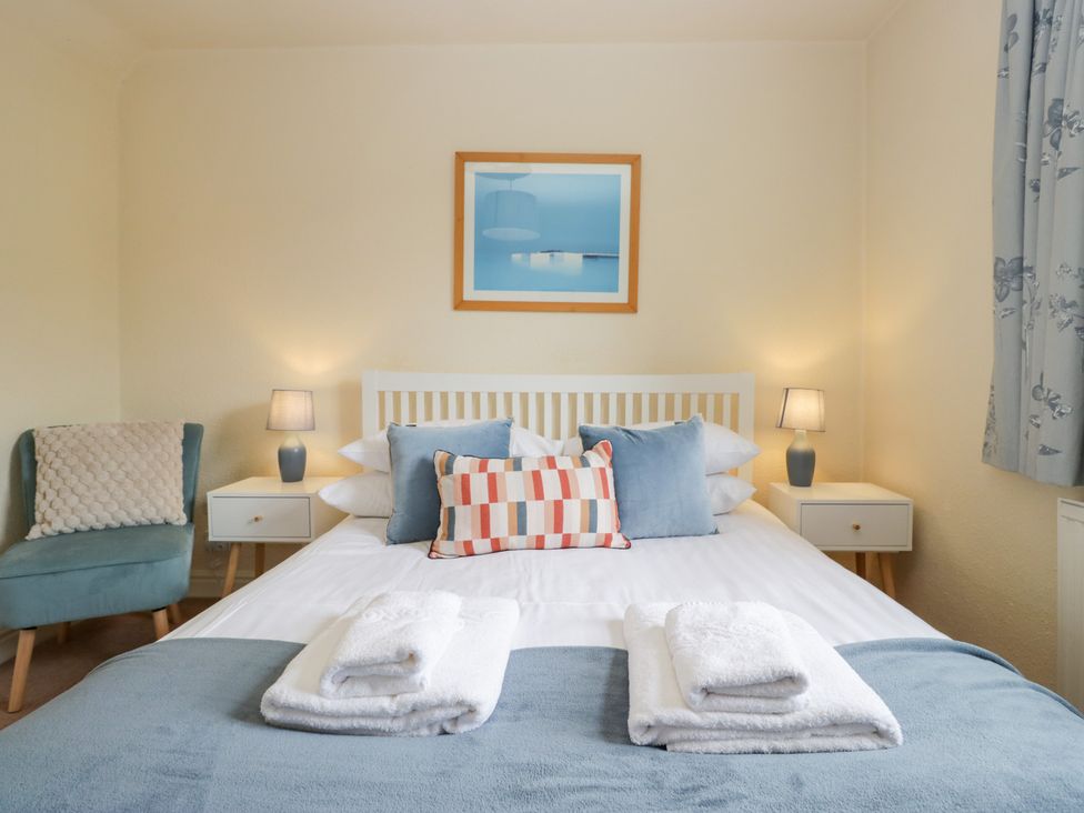 A bedroom with a bed and bedside tables at Rothay Cottage in Ambleside