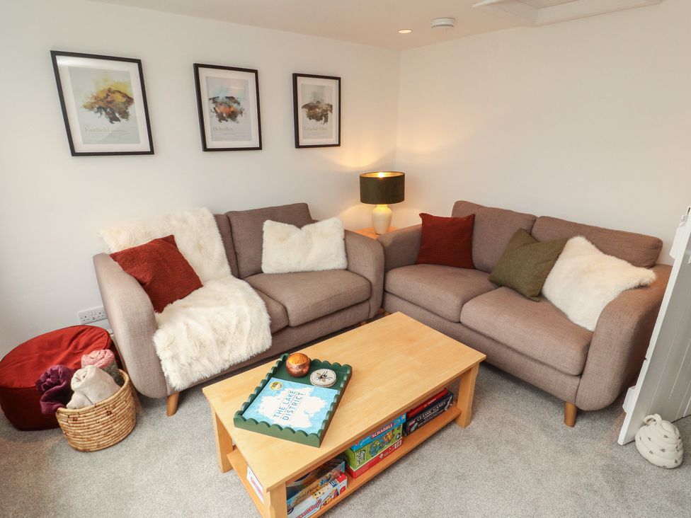A living room with sofas and a coffee table at Rothay Cottage in Ambleside