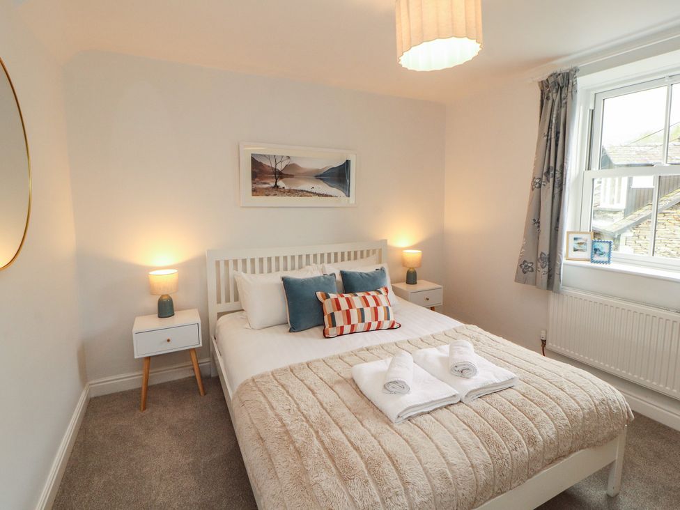 A bedroom with a bed and bedside tables at Rothay Cottage in Ambleside