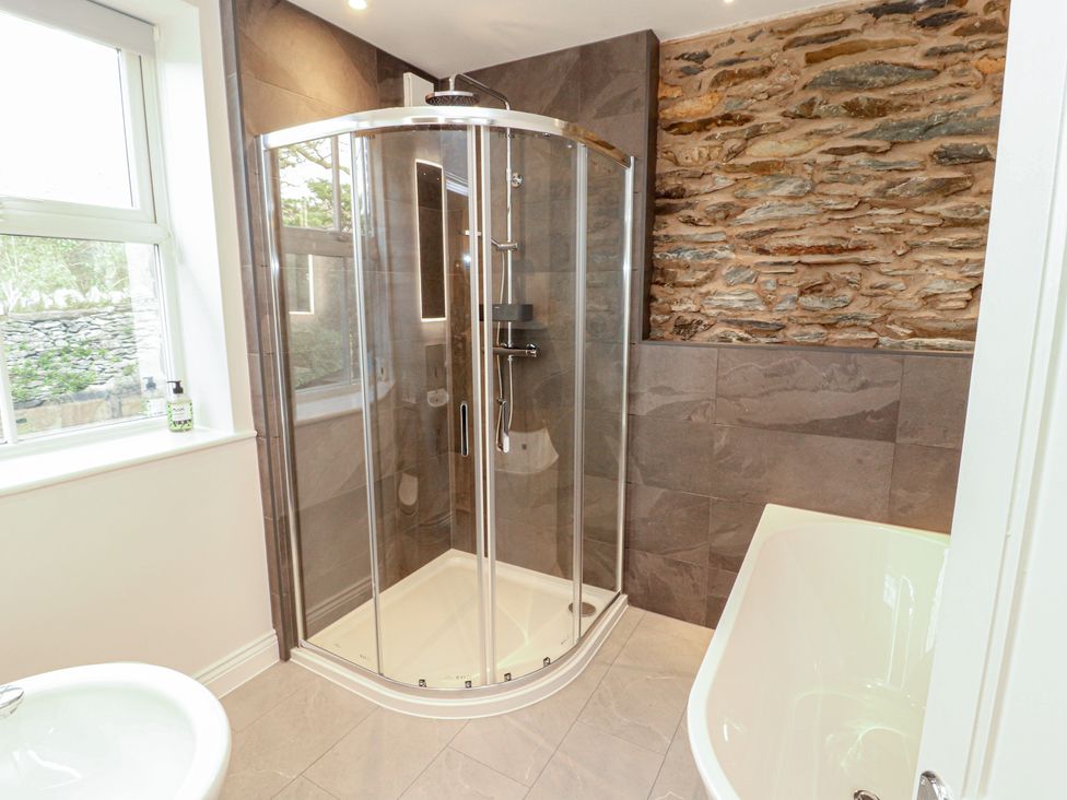 A bathroom with a shower and bathtub at Rothay Cottage Ambleside