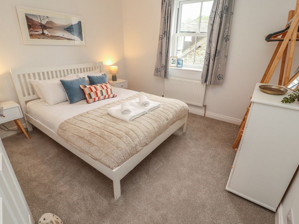 A bedroom with a bed and nightstand at Rothay Cottage in Ambleside
