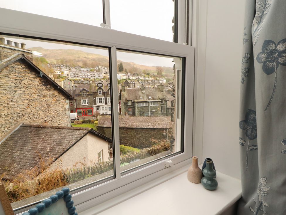 A window with a view of houses and a street at Rothay Cottage in Ambleside
