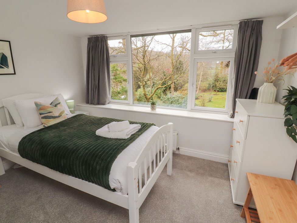 A bedroom with a bed and window at Rothay Cottage in Ambleside