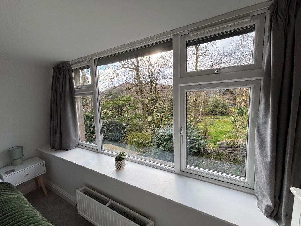 A living room with a window view of the garden at Rothay Cottage Ambleside