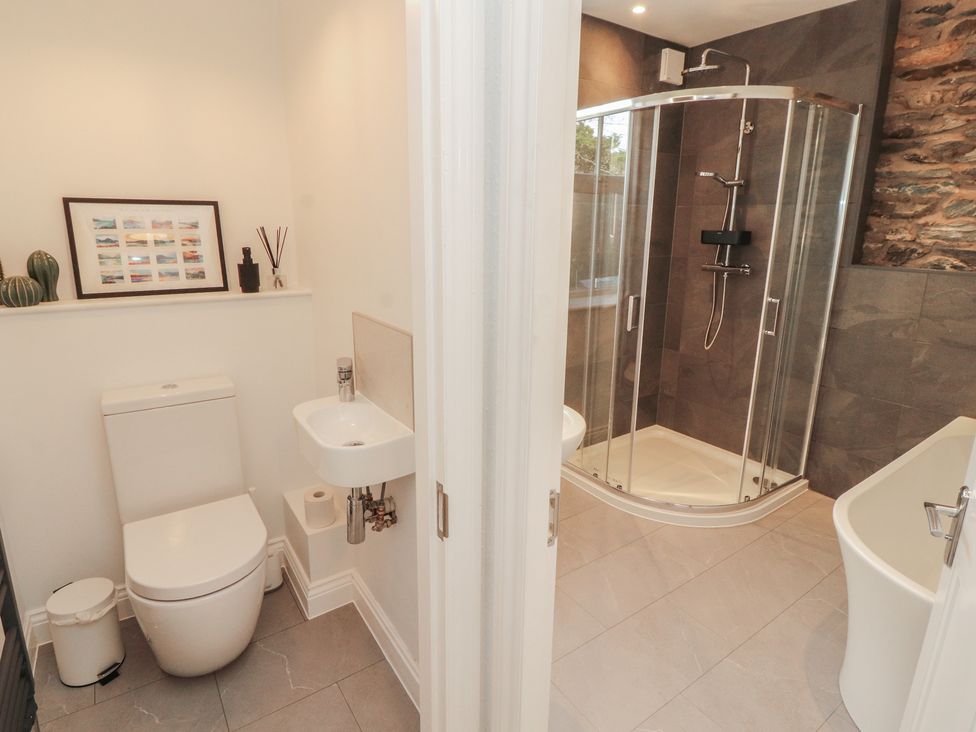 A bathroom with a shower, toilet, and bathtub at Rothay Cottage in Ambleside