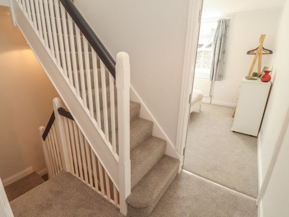 A hallway with stairs leading to an upper floor at Rothay Cottage Ambleside