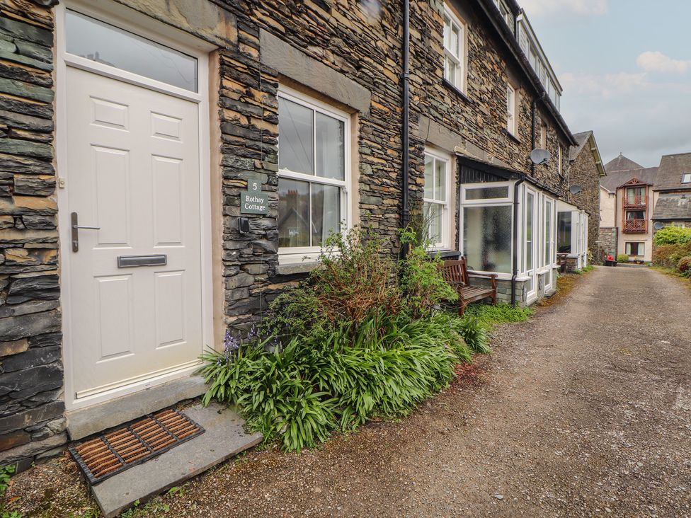 An entrance with a door and sign for Rothay Cottage in Ambleside